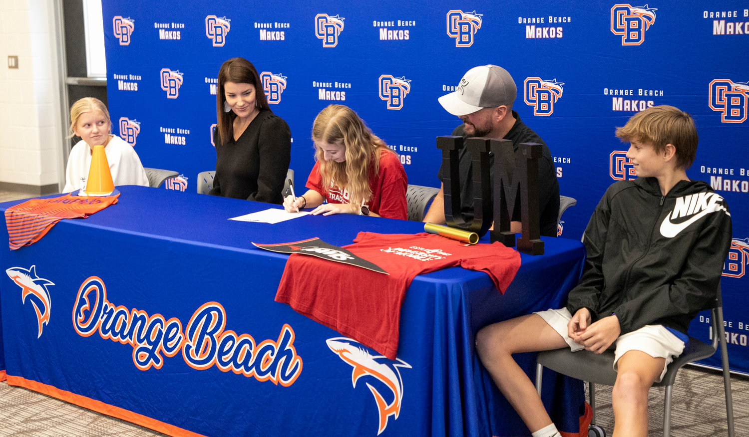Claire Atkins was joined by her family in signing with the University of Mobile cross country and track teams at Orange Beach High School Wednesday, Jan. 18, capping an already decorated running career.
