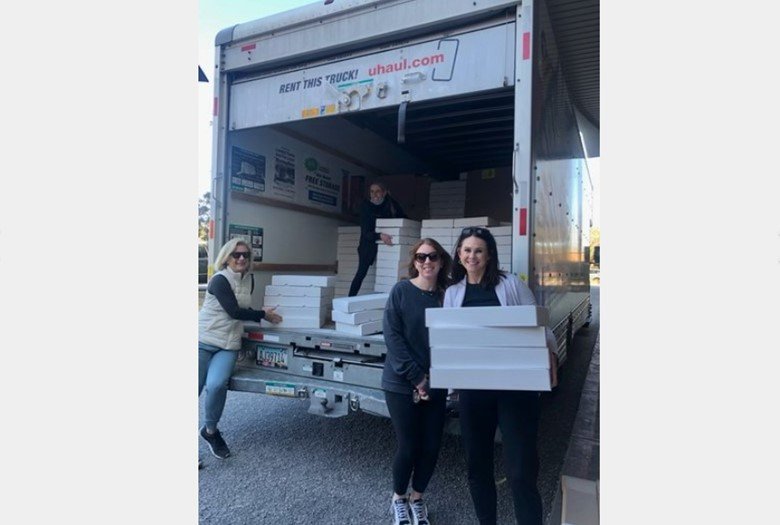 Members of the Eastern Shore Medical Alliance unload thousands of king cakes from Randazzo's Camellia City Bakery in Slidell, Louisiana. The group sells the sweet treat every year to help support its work with local charities.