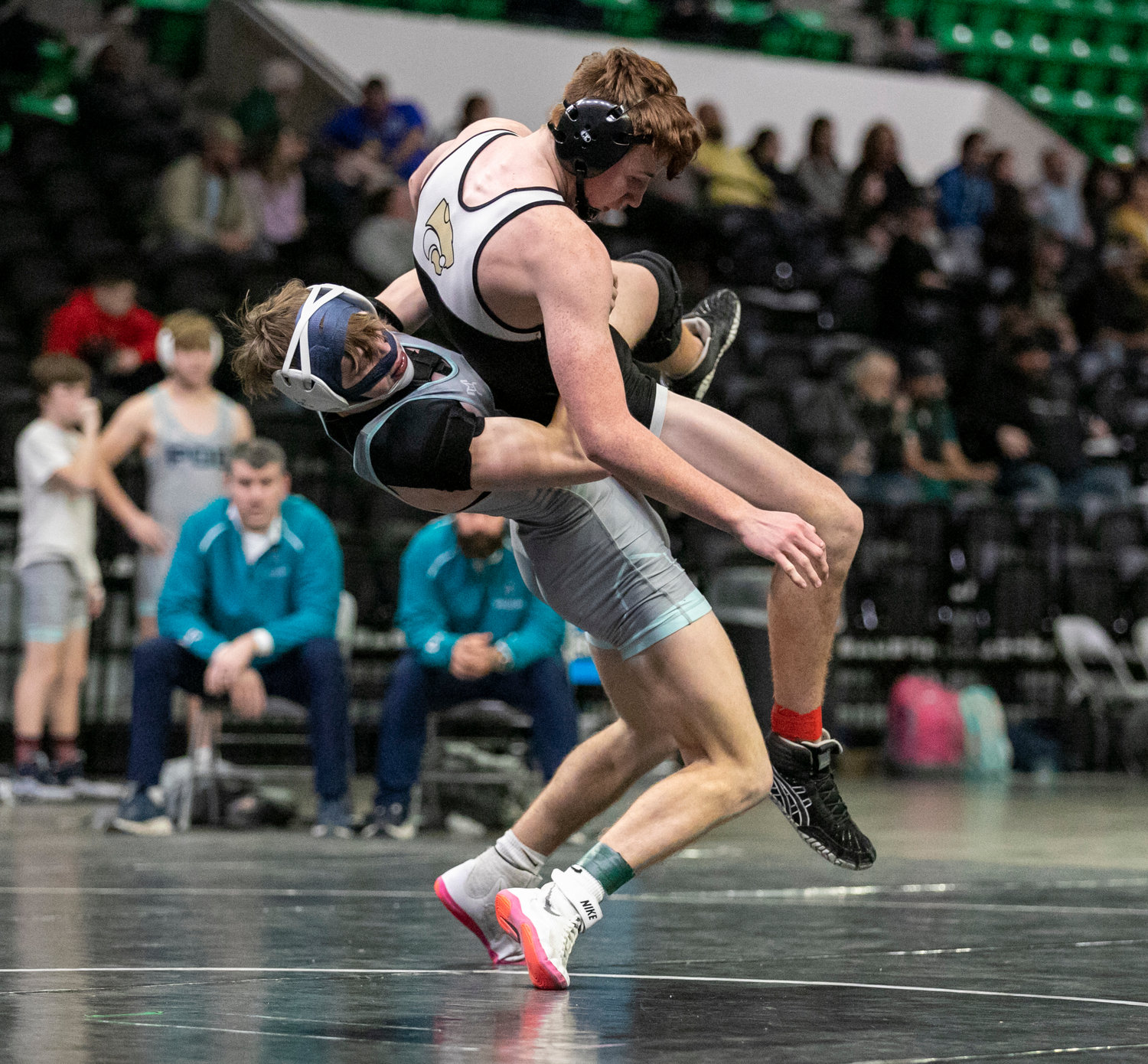 Dolphin senior Nick Carris lifts off with Hayden’s Grant McGill in the 172-pound match Friday night during the consolation finals at Bill Harris Arena in Birmingham. Gulf Shores beat Hayden 37-27 to win the Class 5A dual consolation championship.