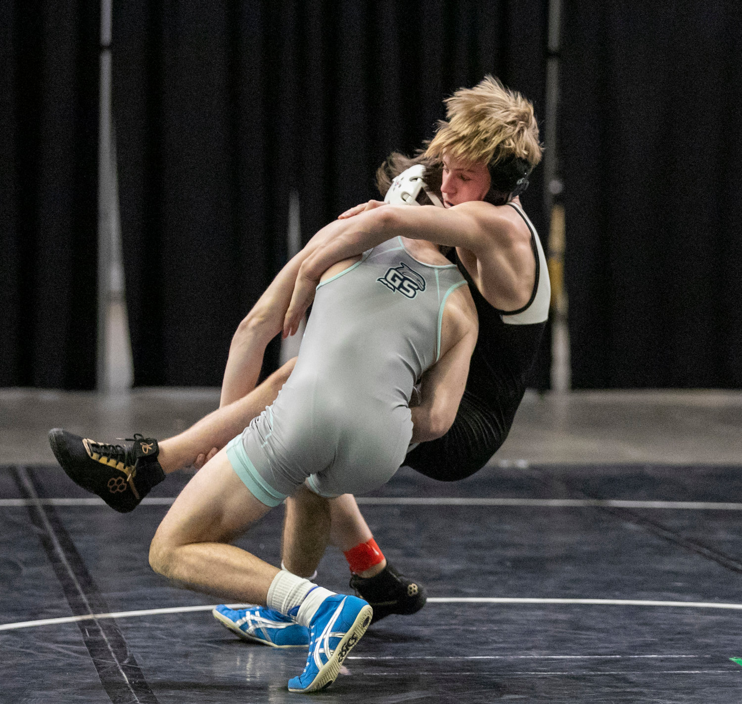 Gulf Shores’ Noah Guthrie secures a takedown of Hayden’s Hudson Best in the final match of the Class 5A consolation championship at the state finals in Birmingham Friday night. Guthrie came through with a pin to seal the Dolphins’ victory over the Wildcats.