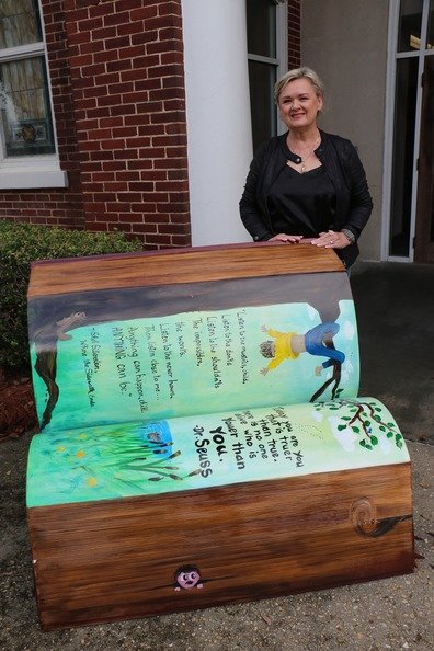 Nancy Self painted one of two benches outside the Bay Minette Library, fashioned to look like giant books.