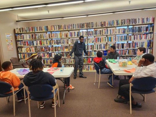 Participants listen to Korey Chapman, organizer of The Art of Manliness - Baldwin County, speak during a session at the Bay Minette Public Library.