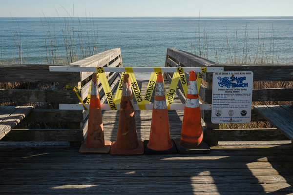 The board walk across from the Gulf Shores Surf & Racquet Club is shown closed on Friday afternoon.