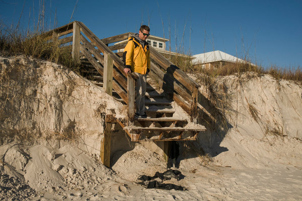 Dustin Word, property manager at the Gulf Shores Surf & Racquet Club, stands on the stairs going to the beach across from the condo complex on West Beach in Gulf Shores on Friday afternoon.