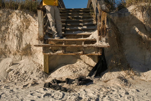 Dustin Word, property manager at the Gulf Shores Surf & Racquet Club, stands on the stairs going to the beach across from the condo complex on West Beach in Gulf Shores on Friday afternoon.