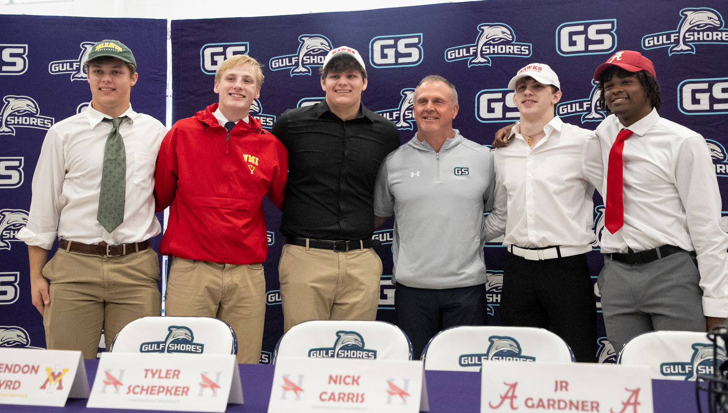 Gulf Shores head football coach Mark Hudspeth joins the five Dolphin signees that put pen to paper on National Letters of Intent Wednesday, Feb. 1, at the high school. Brax Duncan signed with Belhaven, Brendon Byrd chose Virginia Military Institute, Tyler Schepker and Nick Carris penned commitments to Huntingdon and J.R. Gardner signed with Alabama.