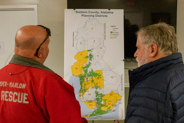 Residents look at a zoning map of Baldwin County prior to a meeting to discuss the proposed planning district east of Fish River at the Fish River-Marlow fire station in Summerdale on Thursday.