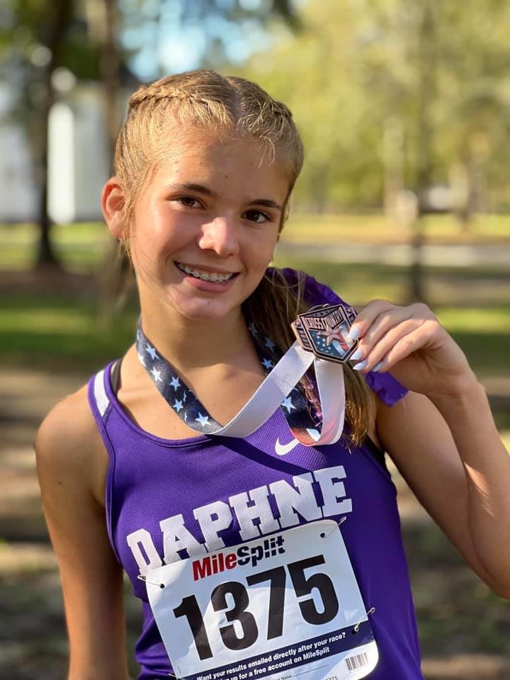 Daphne’s Sophie West shows off the medal she earned for her top-15 finish at the 2021 Class 7A Sectional Championship. West was one of three local runners named AHSAA All-Stars ahead of July’s All-Star Week.