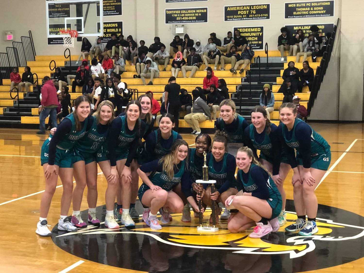 The Gulf Shores Dolphins celebrate with their fourth consecutive postseason area championship following a 35-31 win over Williamson last Thursday, Feb. 9. Gulf Shores was one of nine teams from Baldwin County entering the AHSAA state tournament.