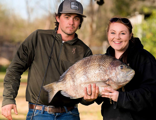 Kendale Jeans and her husband, Donovan, show off the state record sheepshead.