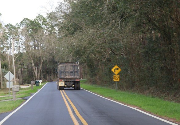 A dump truck drives down Clarke Ridge Road on Tuesday, Feb. 14. The Baldwin County Commission voted Feb. 7 to prohibit trucks on the residential street after hearing complaints that heavy vehicles were damaging the road.