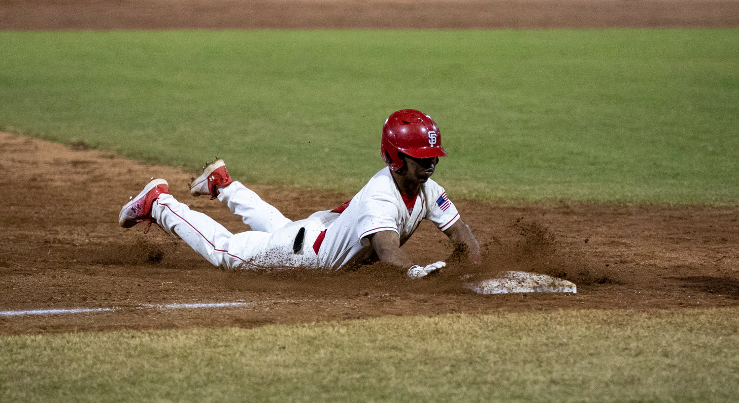 Toro sophomore Nehemiah Hixon slides into third during Spanish Fort’s two-run sixth inning that extended their lead to 7-4 over St. Paul’s during the Opening Day matchup Thursday night, Feb. 16. Hixon was also part of a big double play that kept the Saints off the board in the fifth inning.