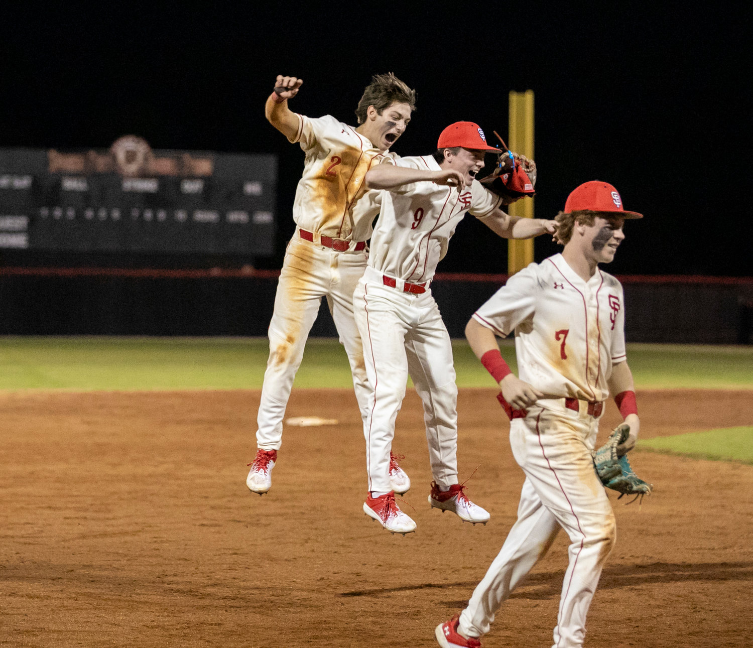 Pierce Dutton (2) and Chris Sullivan (9) leap in celebration of their Opening Day win Thursday, Feb. 16, at Spanish Fort High School. The Toros took home a 7-4 win over St. Paul’s where Dutton delivered the final out on a leaping catch at the wall with the bases loaded.