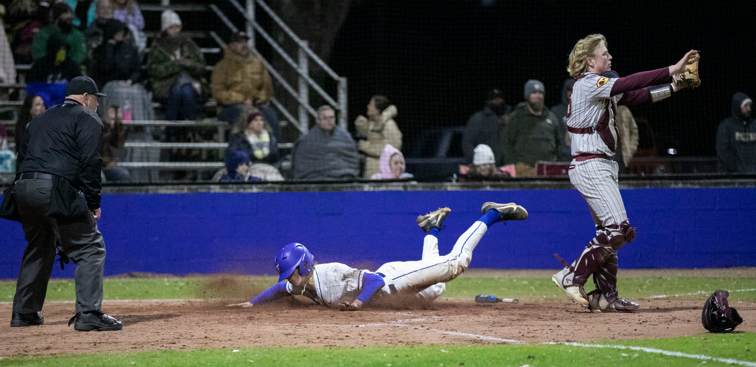 Fairhope junior Nolan Phillips slides in with one of 10 Pirate runs that helped the hosts grab their first win in their first game, 10-1, over Robertsdale Friday night at home. Phillips provided two runs scored on the night.