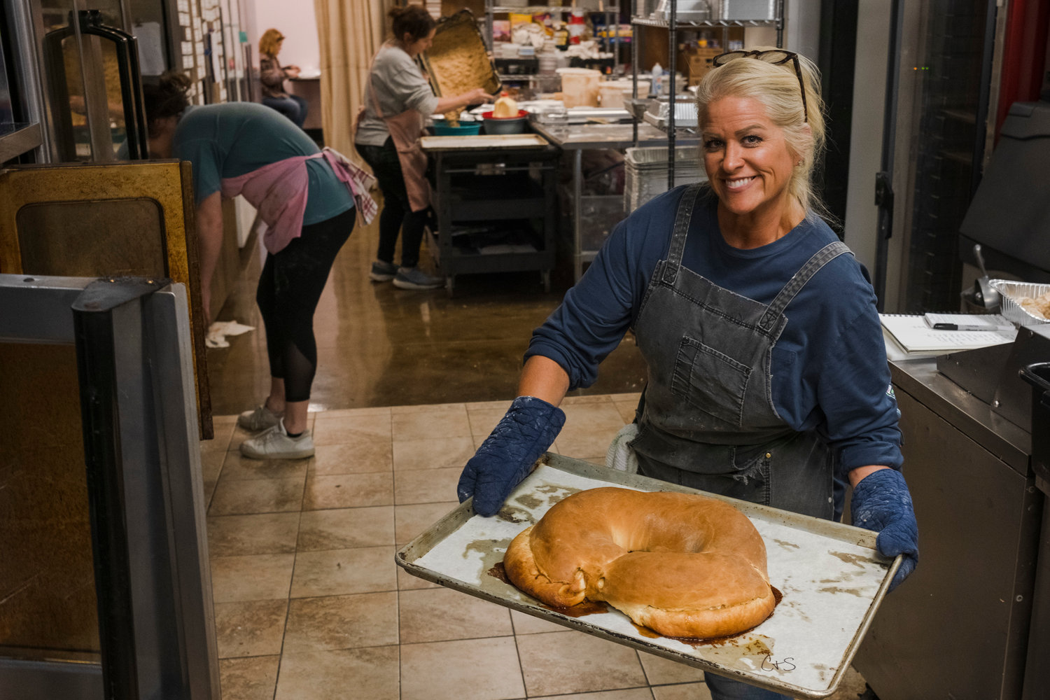 Laura Stafford removes the crawfish king cake from the oven.