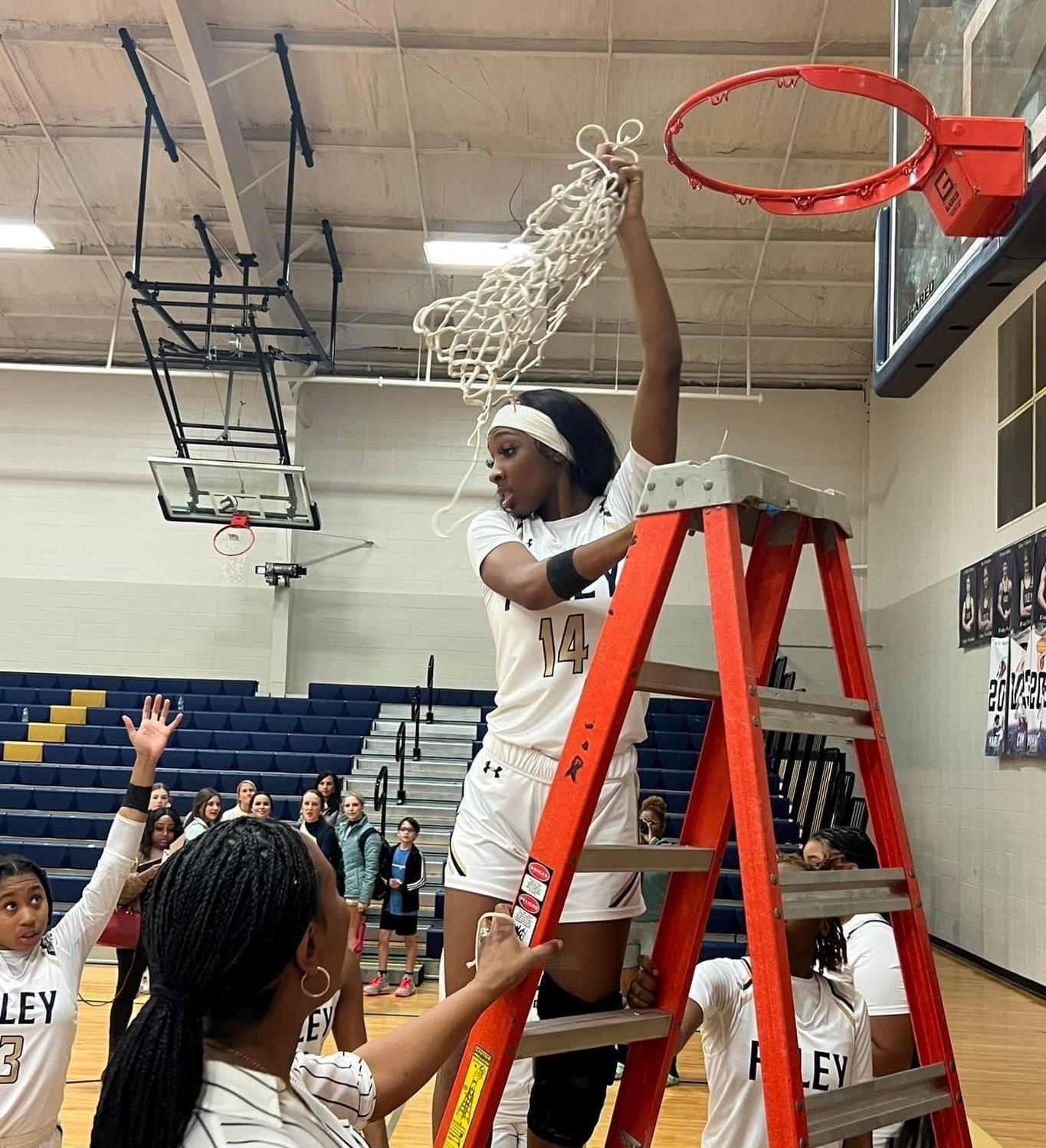 Foley senior Jestiny Dixon cuts down the nets after the Lions’ Class 7A Area 2 championship over Daphne at home Feb. 10. Dixon was one of five local players named to all-state teams by the Alabama Sports Writers Association and represented the Lions on the second team following their first run to the final four.