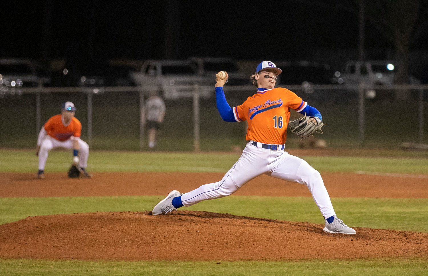 Orange Beach’s Rylan Gober unloads a pitch during the second inning of the Makos’ contest against the Gulf Shores Dolphins Friday night on the road. It was the first meeting between the island schools on the baseball diamond.