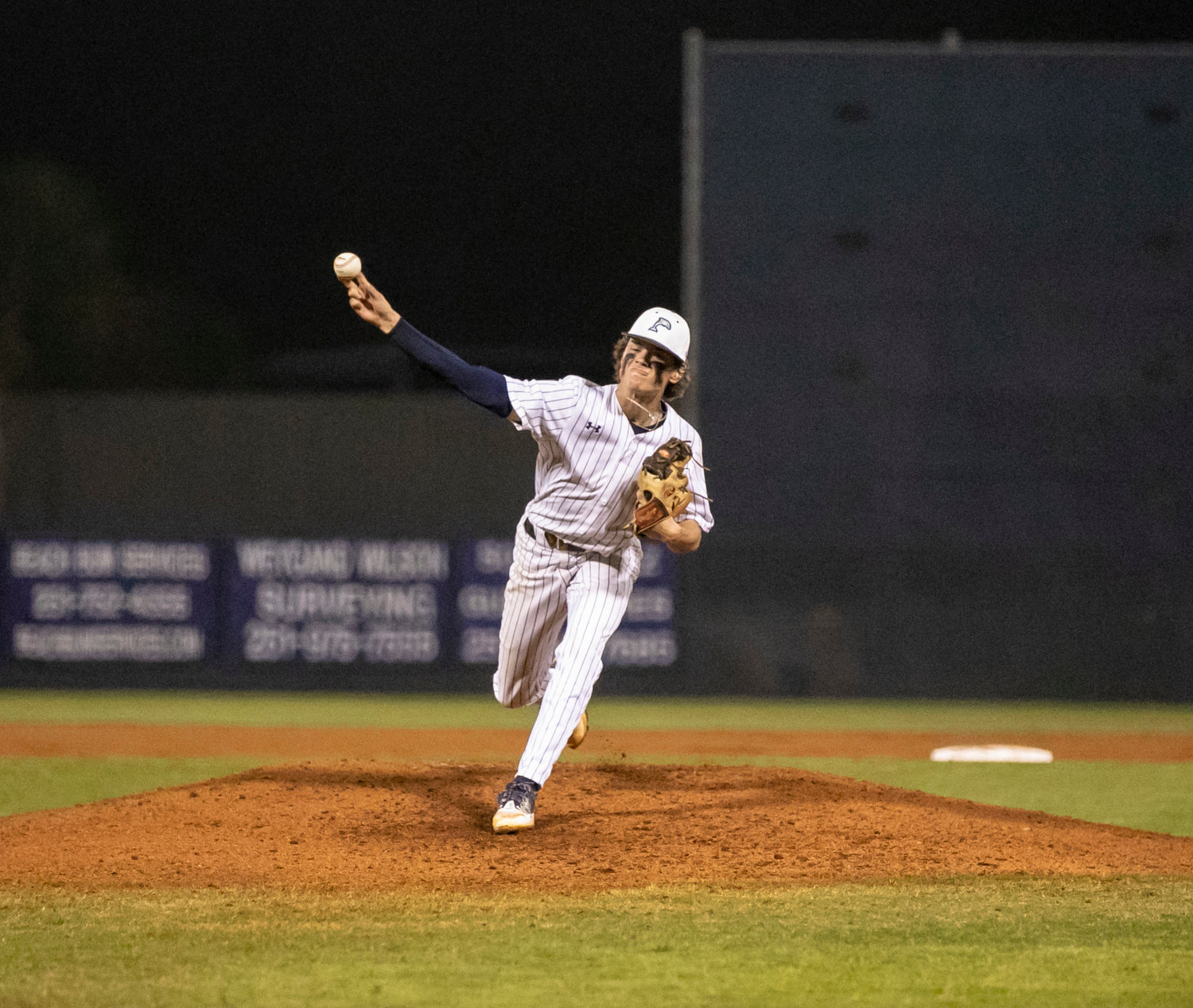 Dolphin junior Connor Gehr fires a pitch during the Prep Baseball Report South Alabama Showdown where Gulf Shores played Orange Beach for the first time in program history. Gehr earned the win on the mound and did damage at the plate as well.