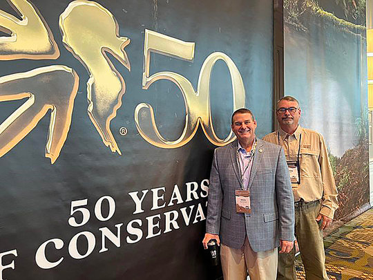 Alabama Conservation Commissioner Chris Blankenship, left, and NWTF Alabama State Chapter President Craig Harris celebrate NWTF's 50th anniversary.