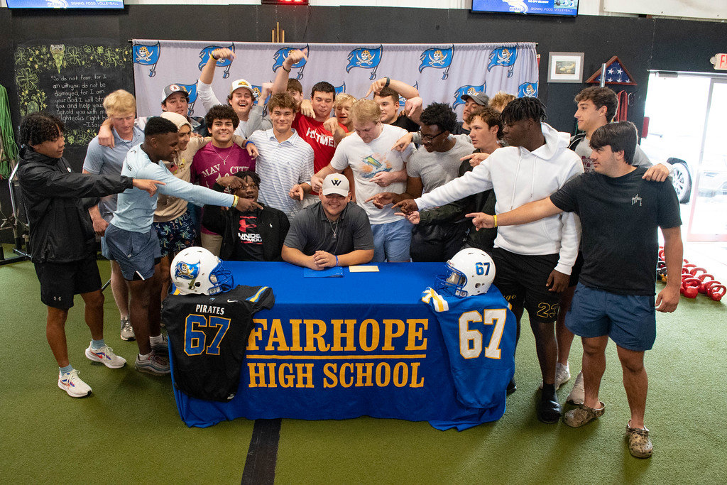 Pirate senior Mickey Herrick was joined by teammates in celebrating his signing with the Warner Royal football program Sunday, March 12, at No Off Season training facility in Daphne. The Fairhope center/long snapper helped his squad surpass 300 points scored and climb to its highest state ranking since 2014.