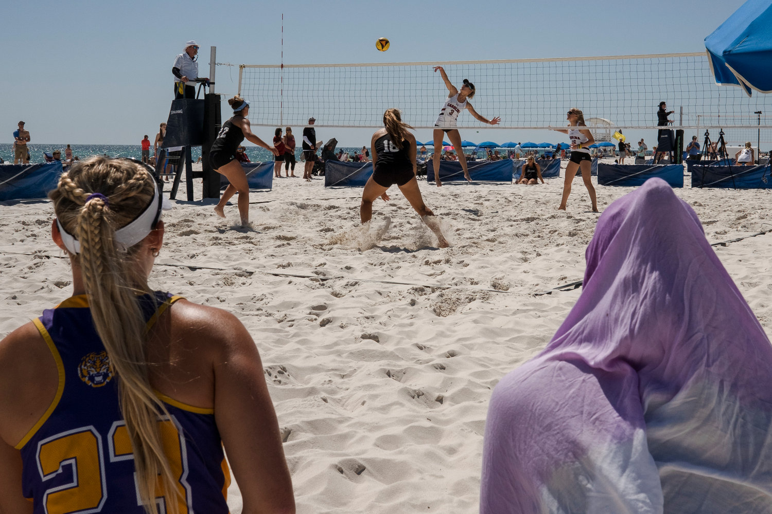 LSU players watch South Carolina and Tulane play a match during last year’s March to May tournament in Gulf Shores March 20, 2022. The white-sand beaches of the Alabama Gulf Coast will once again be filled with top collegiate beach volleyball squads this weekend during the fifth annual spring break tournament.