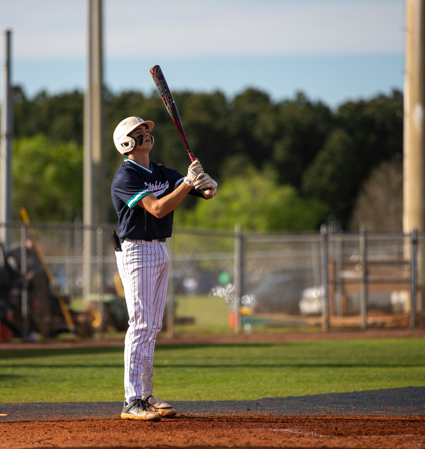 Dolphin senior Logan Allen prepares for a third-inning at-bat against the Muskogee Roughers in Gulf Shores’ first game of the Gulf Coast Classic tournament at home last Monday afternoon. Allen collected a walk and a single in the Dolphins’ 11-0 win in the interstate battle.