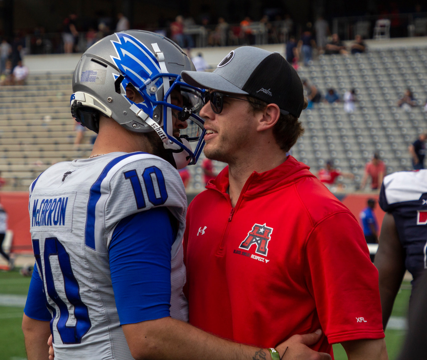 Battlehawks quarterback AJ McCarron and Roughneck quarterback Brandon Silvers share an embrace after Sunday’s game in Week 7 of the XFL season between Houston and St. Louis. TDECU Stadium served as the reunion spot for the pair of lower Alabama quarterbacks who share an offseason trainer and quarterback coach.