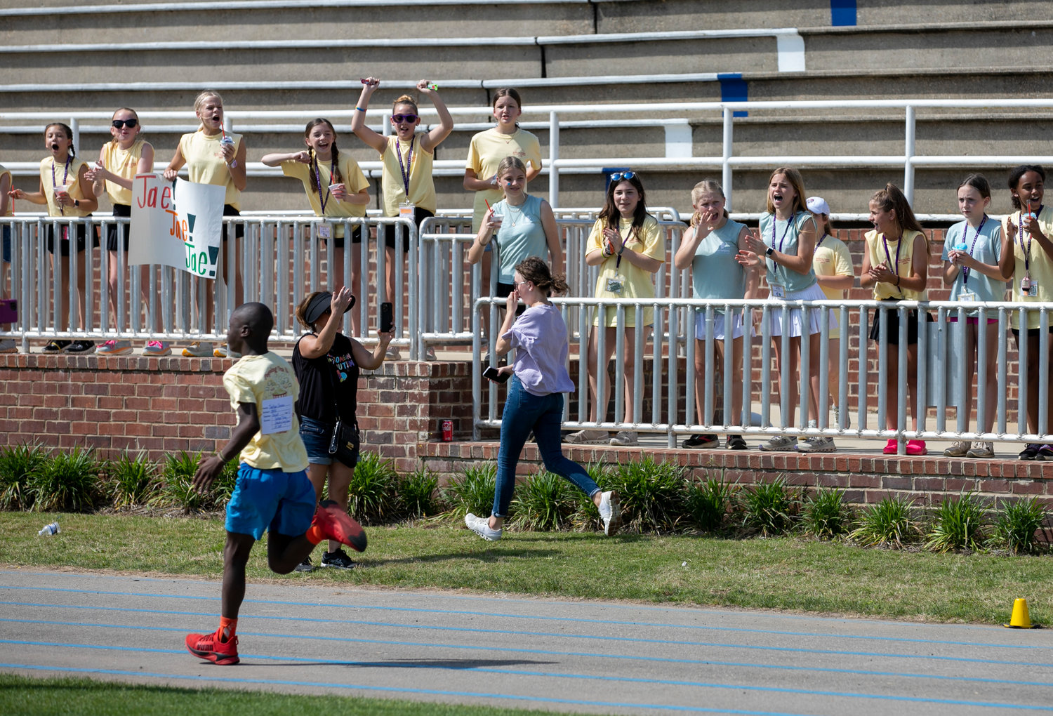 Jackson Johnson is cheered on by his classmates from Daphne East Elementary School during a running event at the Baldwin County Spring Games Thursday, April 6, at Fairhope Municipal Stadium.