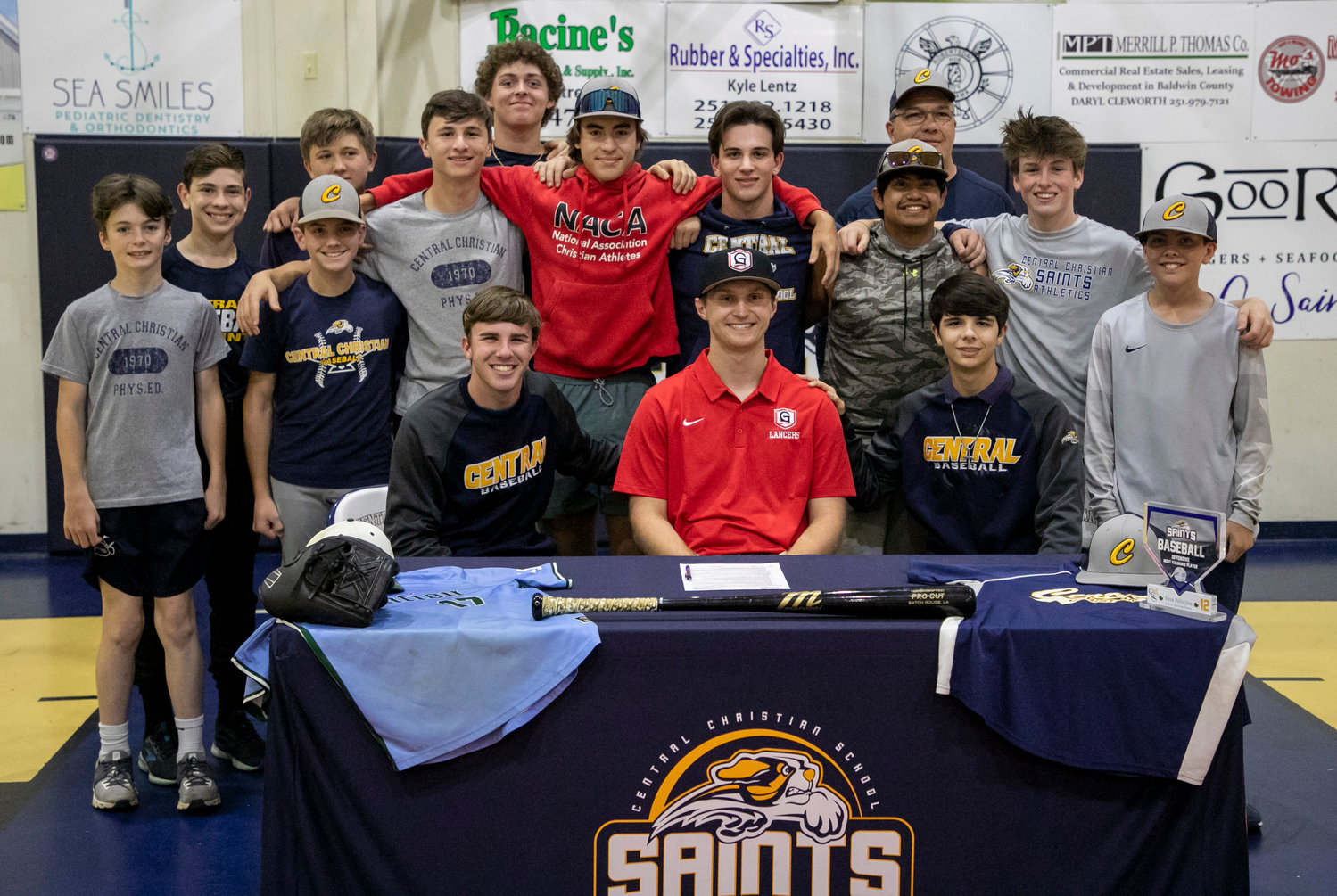 Baseball teammates of Steen Bellerjeau celebrated his signing with the Grace College Lancers Monday, April 10, at Central Christian School in Robertsdale. Bellerjeau said the biggest goal of his senior season was to show his younger teammates how to be successful for years to come.