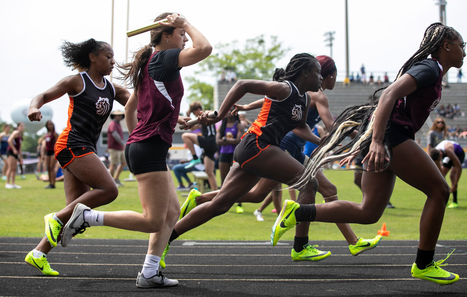 Baldwin County sophomore Alanna Sanders hands off to freshman Talijia Brown while Robertsdale senior Olivia Bundy exchanges with sophomore Angelia Bercant in the first transfer of the 4x100-meter relay race at the Baldwin County Public Schools track and field championship meet in Daphne Tuesday afternoon.