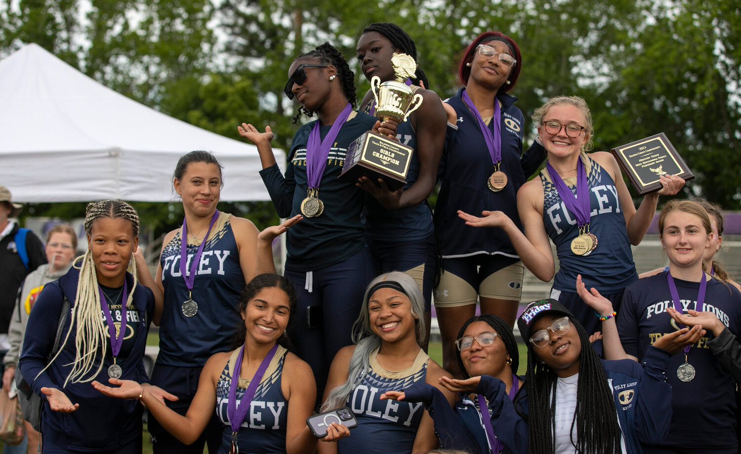 The Foley Lion girls’ track team celebrates their team title at Baldwin County Public Schools track and field championship at Jubilee Stadium in Daphne Tuesday, April 18. The squad earned 21 podium finishes with top-three spots as well as the most outstanding female performer in junior Hope Collins.