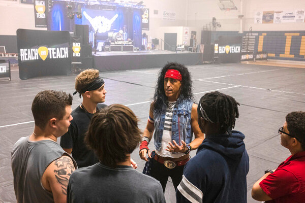 Cameron Flener, lead singer of the Velcro Pygmies, talks with Foley High students who helped produce the band's concert at the school last week.