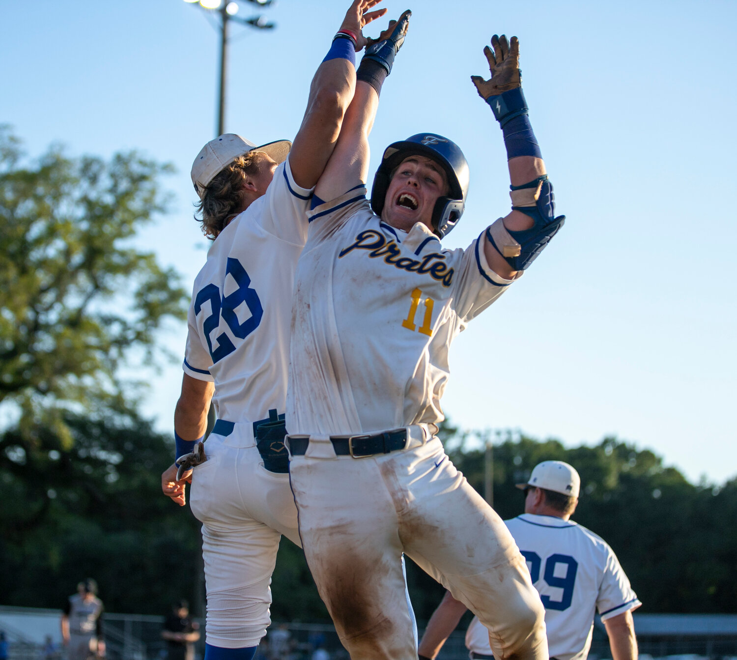 Hollon Brock and Caden Creel celebrate Brock’s two-RBI double that tied Game 1 of the Class 7A first-round state playoff series between Fairhope and Smiths Station Friday, April 28, at Volanta Park.