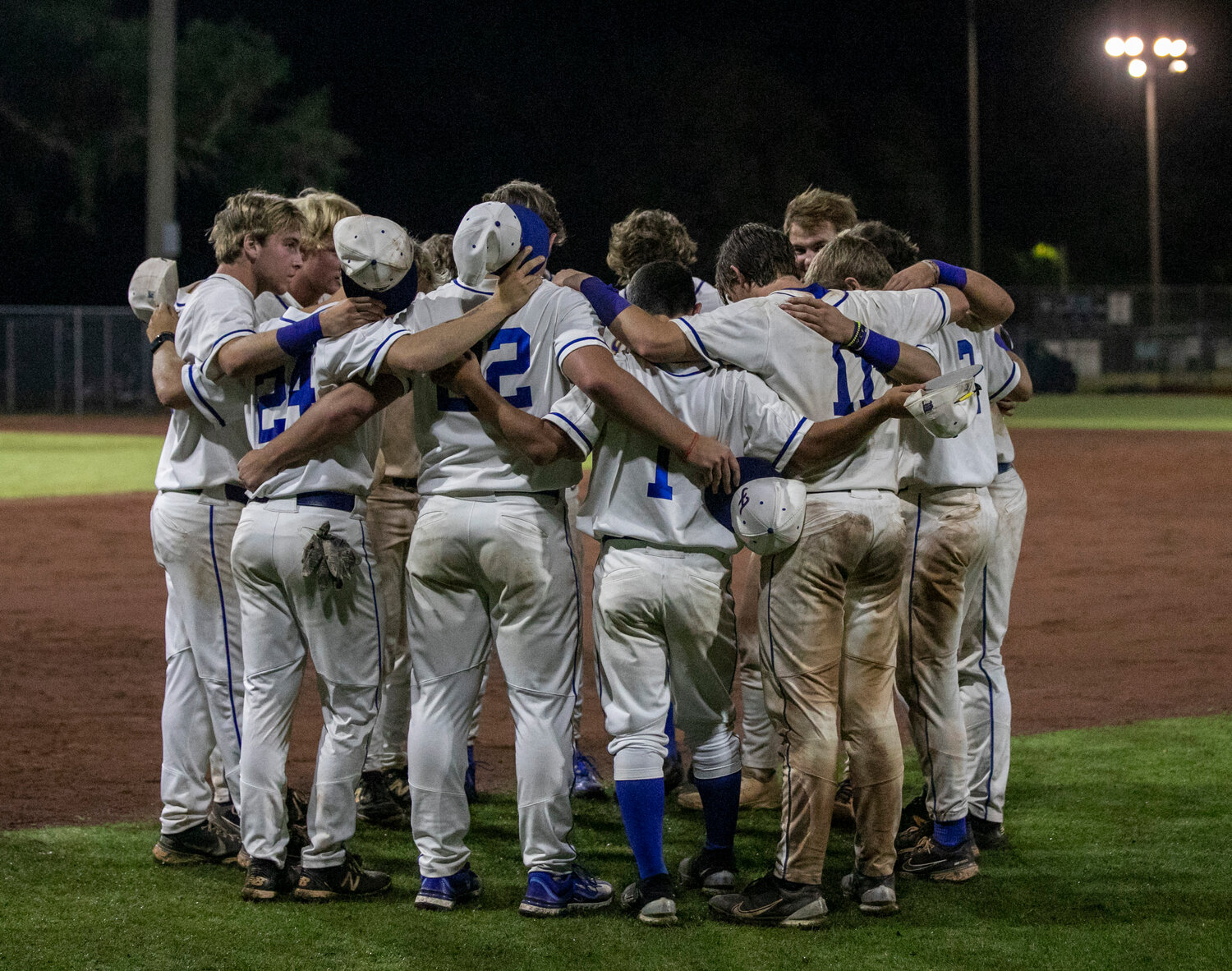 The Fairhope seniors meet for one last huddle together in the outfield of Mike Fillingim Field at Volanta Park after their season came to an end in the first round of the state playoffs to Smiths Station.
