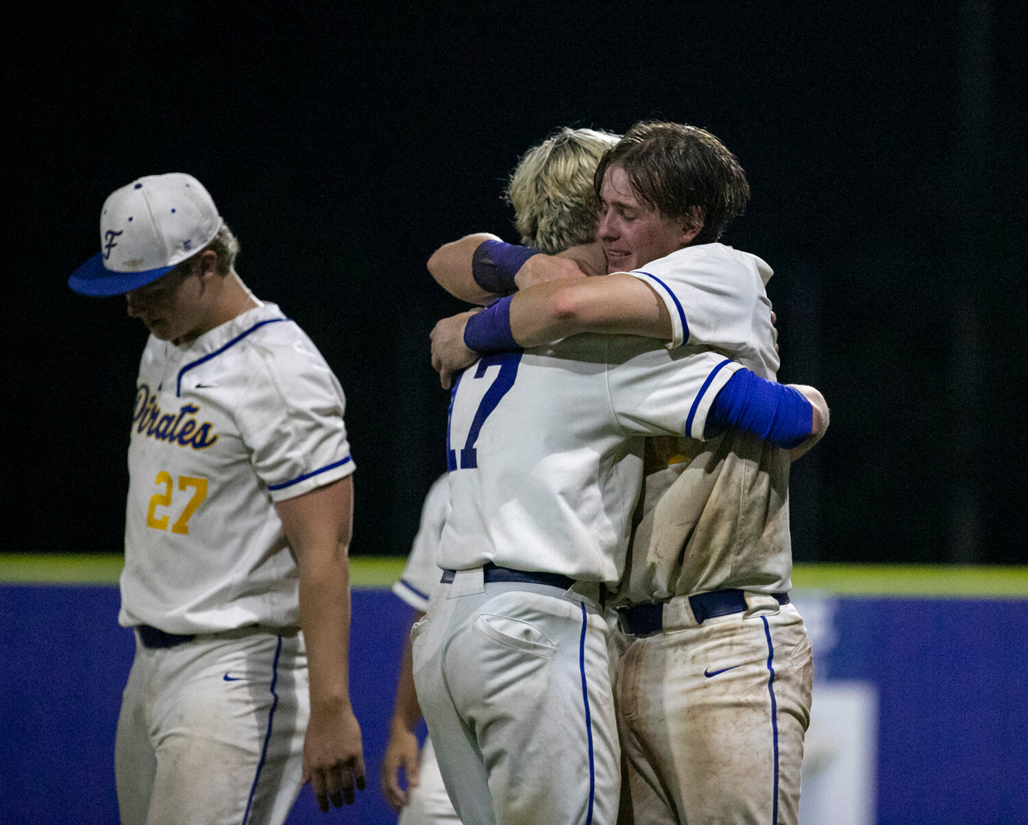 Hollon Brock bearhugs Julian Callahan after the Fairhope Pirates were swept by the Smiths Station Panthers in the first round of the Class 7A state playoffs Friday, April 28, at Volanta Park in Fairhope.