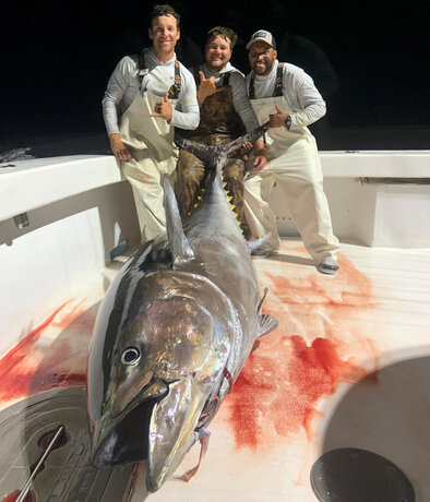 Deck hands, from left, Jake Rezner, Grady Gunn and Jacob Harris, celebrate hauling in the huge bluefin onto the Intimidator's deck.