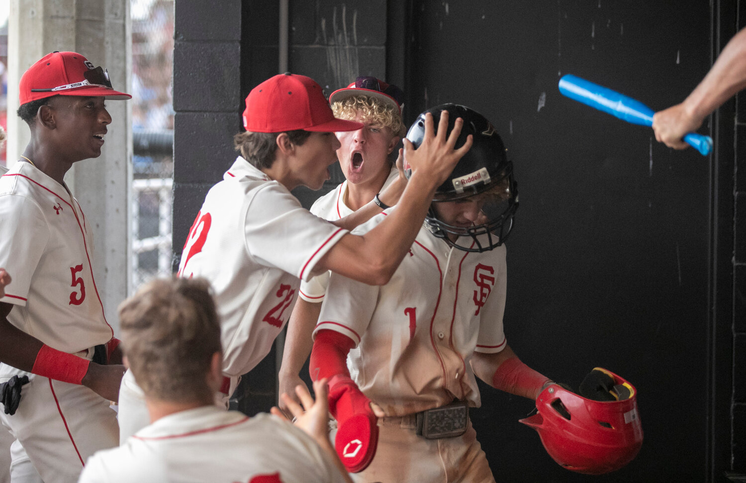 Spanish Fort senior Blake Smith is greeted by his teammates after coming around to score a run in the second inning that helped the Toros erase an early deficit to the Saraland Spartans in Game 3 of the AHSAA state quarterfinal series on the Hill Saturday, May 6.