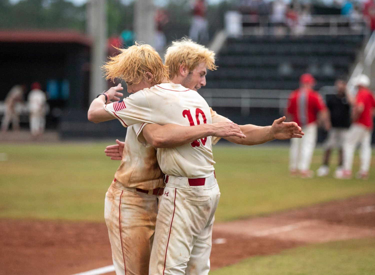 Brayden Cooper and Newton Gardner collide for a bearhug following the walk-off win that sent the Spanish Fort Toros to the state semifinals for the first time since 2015. Cooper hit in Gardner for the winning run in the eighth inning.