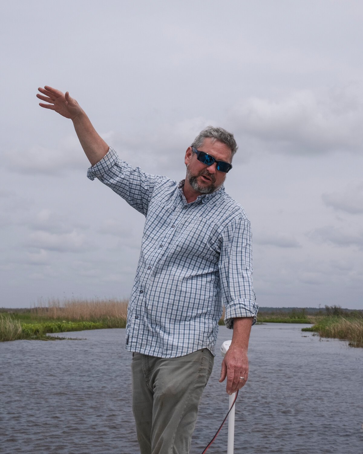 MICAH GREEN / GULF COAST MEDIA

Ben Raines gives passengers background to an area of wetlands.