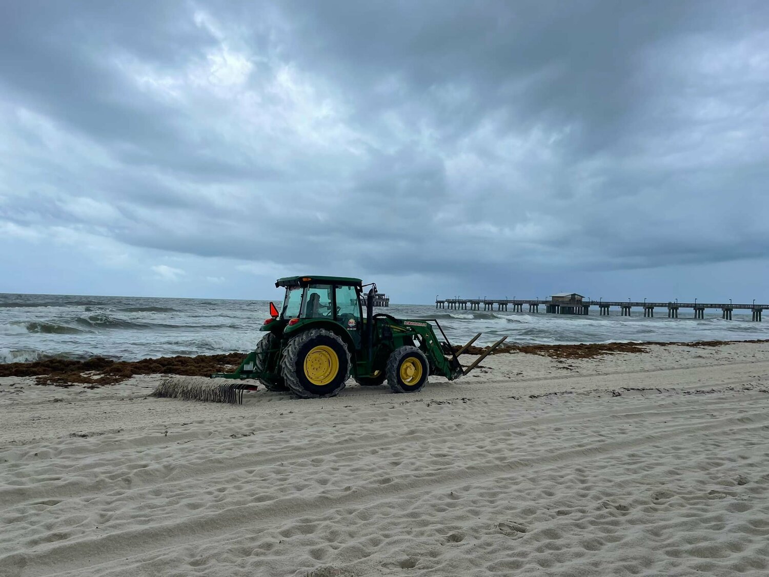 Crews move sargassum off the beaches in Gulf State Park in May of 2022.