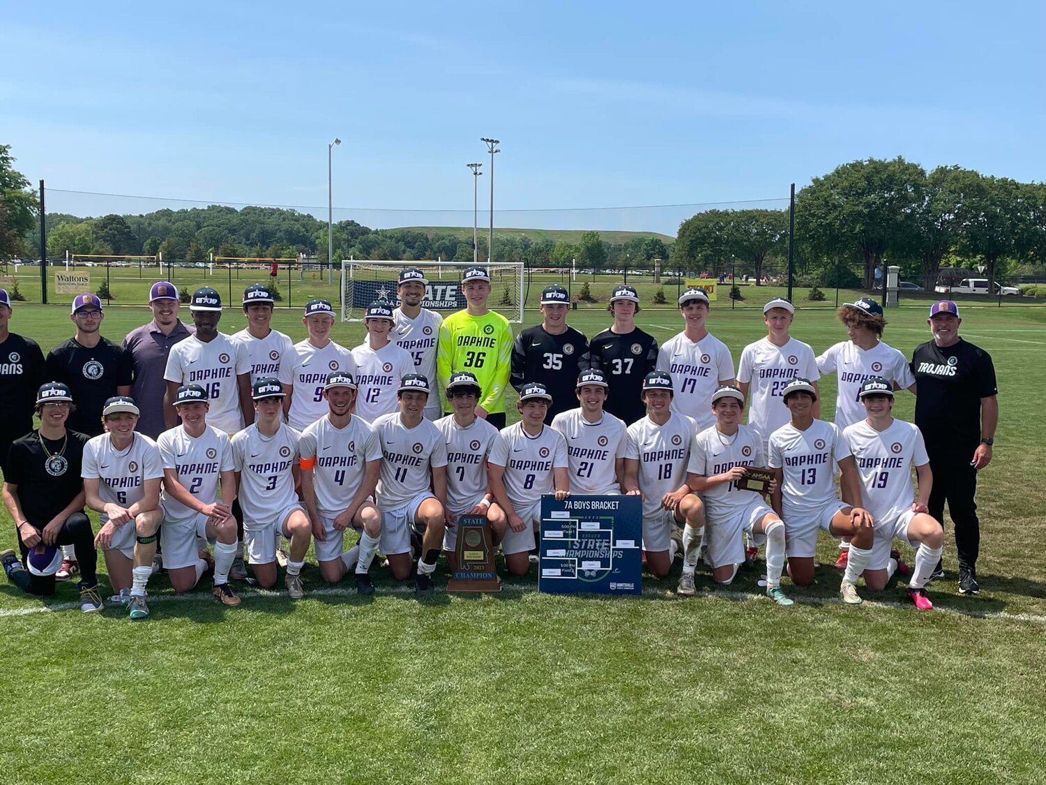 The Daphne Trojans pose with their second straight AHSAA Class 7A state championship after a 3-1 win over Huntsville Saturday, May 13, at John Hunt Park. University of Mobile signee Noah Miller, front row third from right, was named state tournament MVP with a pair of goals in the title match.