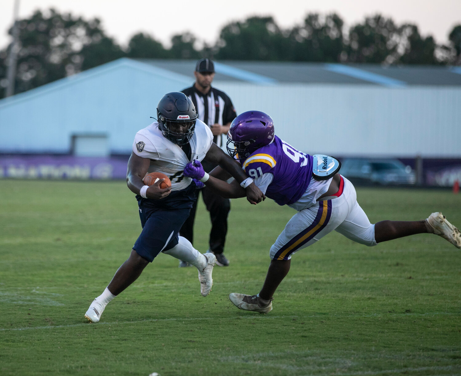 Foley rising senior Kolton Nero escapes a Daphne Trojan tackler in the second quarter of exhibition action Friday, May 19, at Jubilee Stadium.