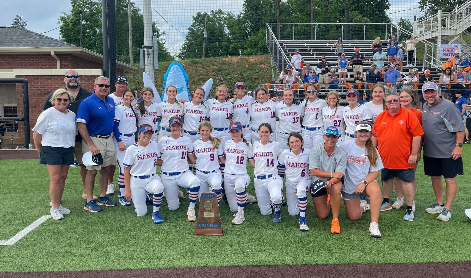 The Orange Beach Makos pose with their third consecutive AHSAA Blue Map trophy as softball state champions, this time on the Class 4A stage after a 5-0 win over Houston Academy Saturday, May 20, at Jacksonville State University.
