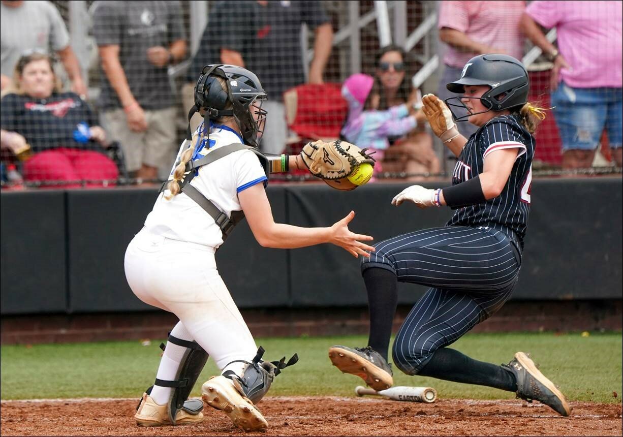 Pirate sophomore catcher Olivia Stewart prepares to tag Hewitt-Trussville’s Olivia Faggard in a close play at the plate during the Class 7A state championship game Saturday, May 20, at Choccolocco Park in Oxford. Stewart was one of three that represented Fairhope on the all-state tournament team.