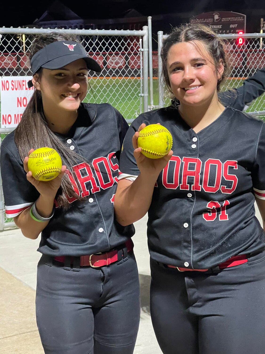 Ella Grace Nobles (31) and Haley Hart from Spanish Fort show off their home run balls following action March 22 in Saraland. Nobles was named to the South All-Star softball roster Monday, May 22, and will be joined by two other local athletes at the AHSAA All-Star Week in July.