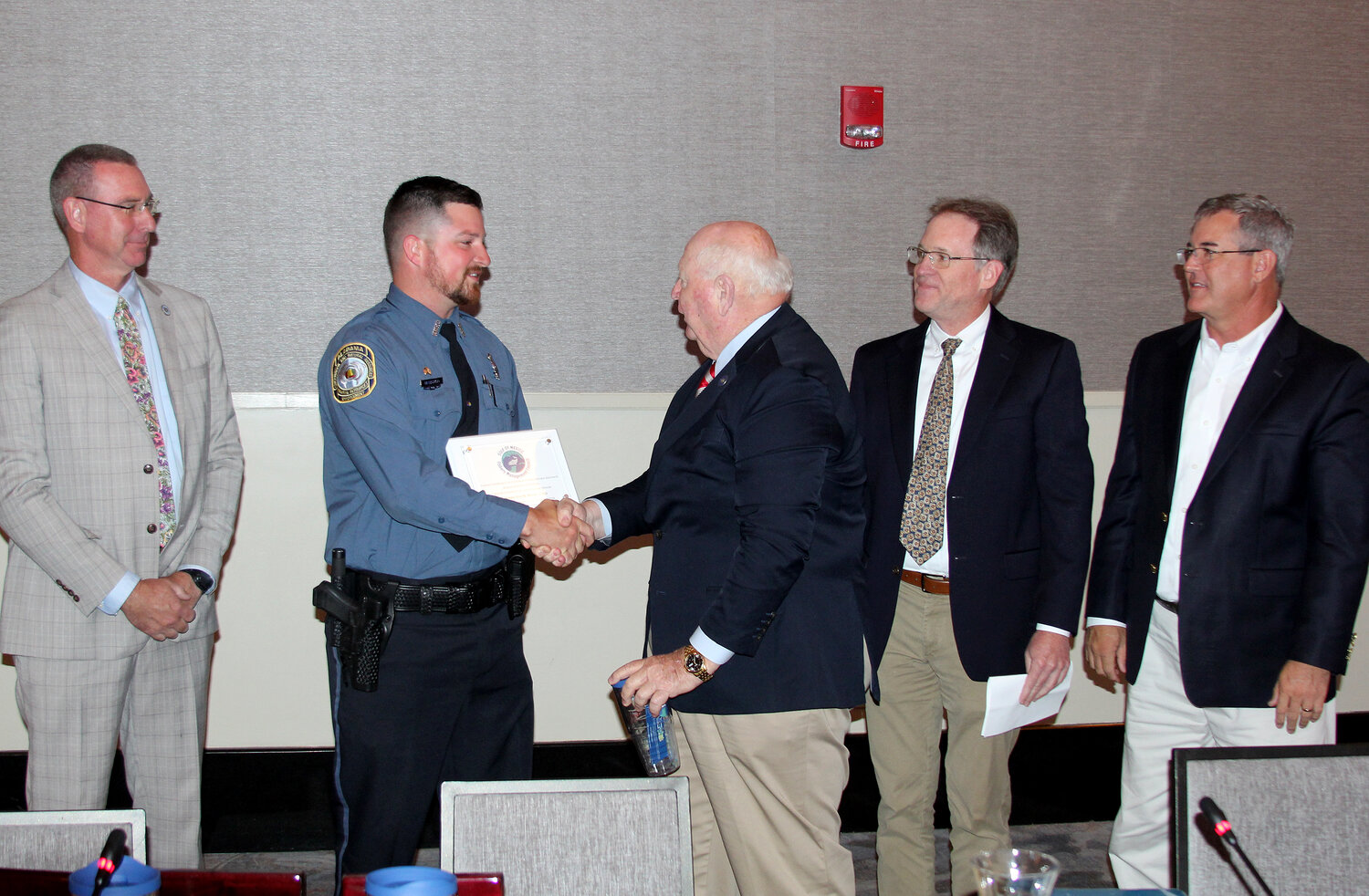 Alabama Marine Resources Officer Chance Mancuso receives the Gulf of Mexico Fishery Management Council Officer of the Year Award from Joe Spraggins of the Gulf Council's law enforcement committee.