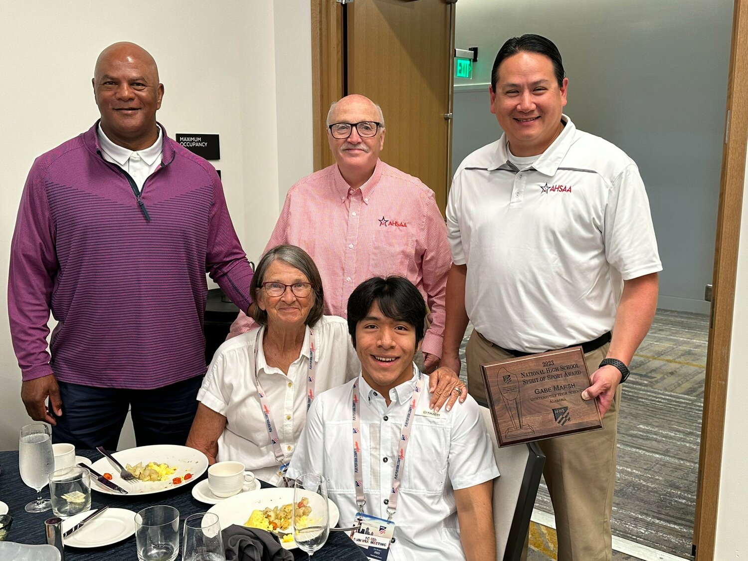 Gabe Marsh and his mother Ann with AHSAA Executive Director Alvin Briggs, Marvin Chou and Ron Ingram at Wednesday’s Spirit of Sport/Heart of the Arts Breakfast at the NFHS Summer Meeting in Seattle. Marsh is a recent graduate of Guntersville High School who won state titles at the Alabama High School Athletic Association state championships and the Alabama Para Olympics.