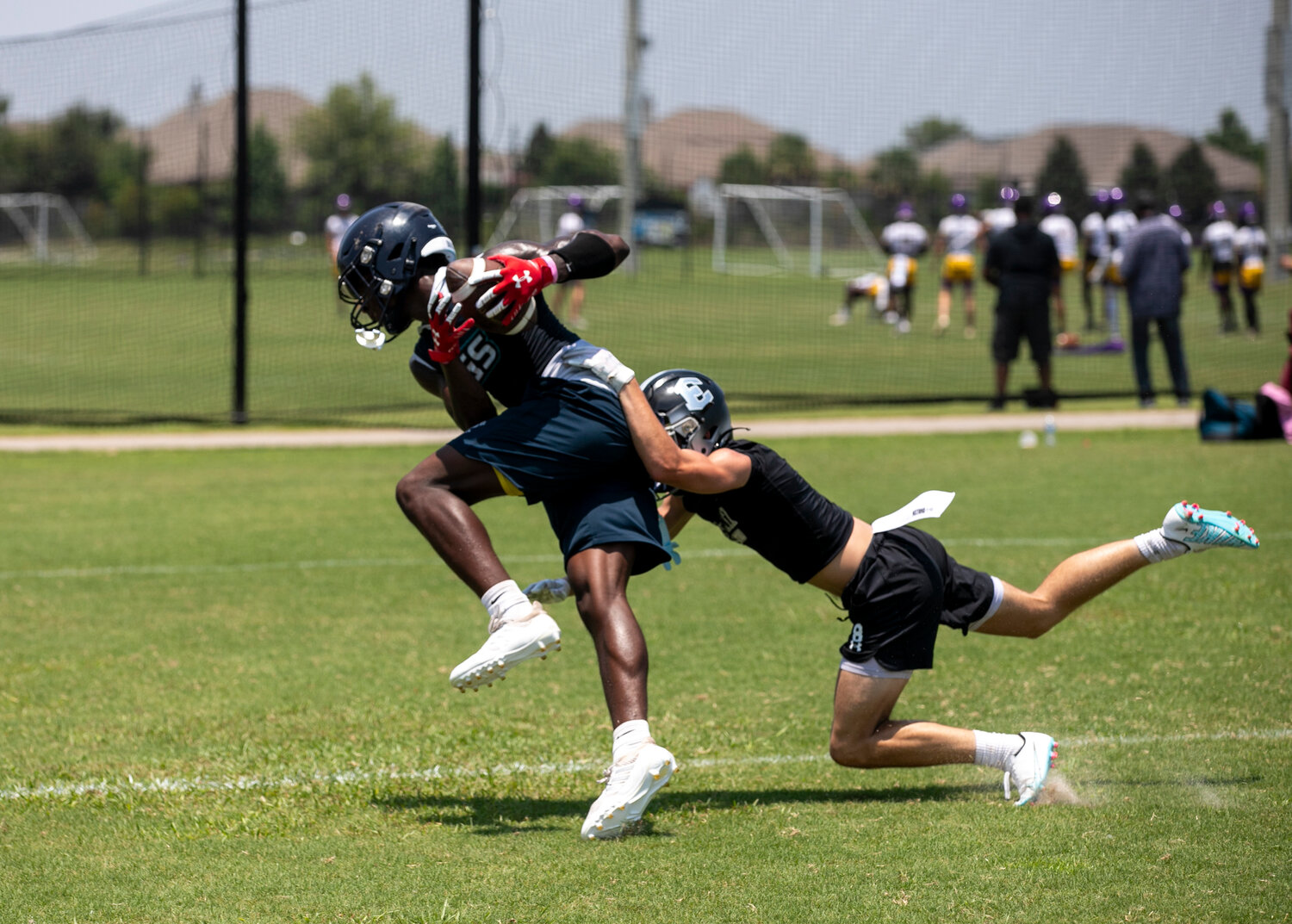 Gulf Shores senior Braden Jackson fights for extra yards and tumbles into the end zone for a touchdown during the Dolphins’ contest against the Elberta Warriors in the first round of bracket play Thursday, June 29, at the Foley 7-on-7 Showdown.