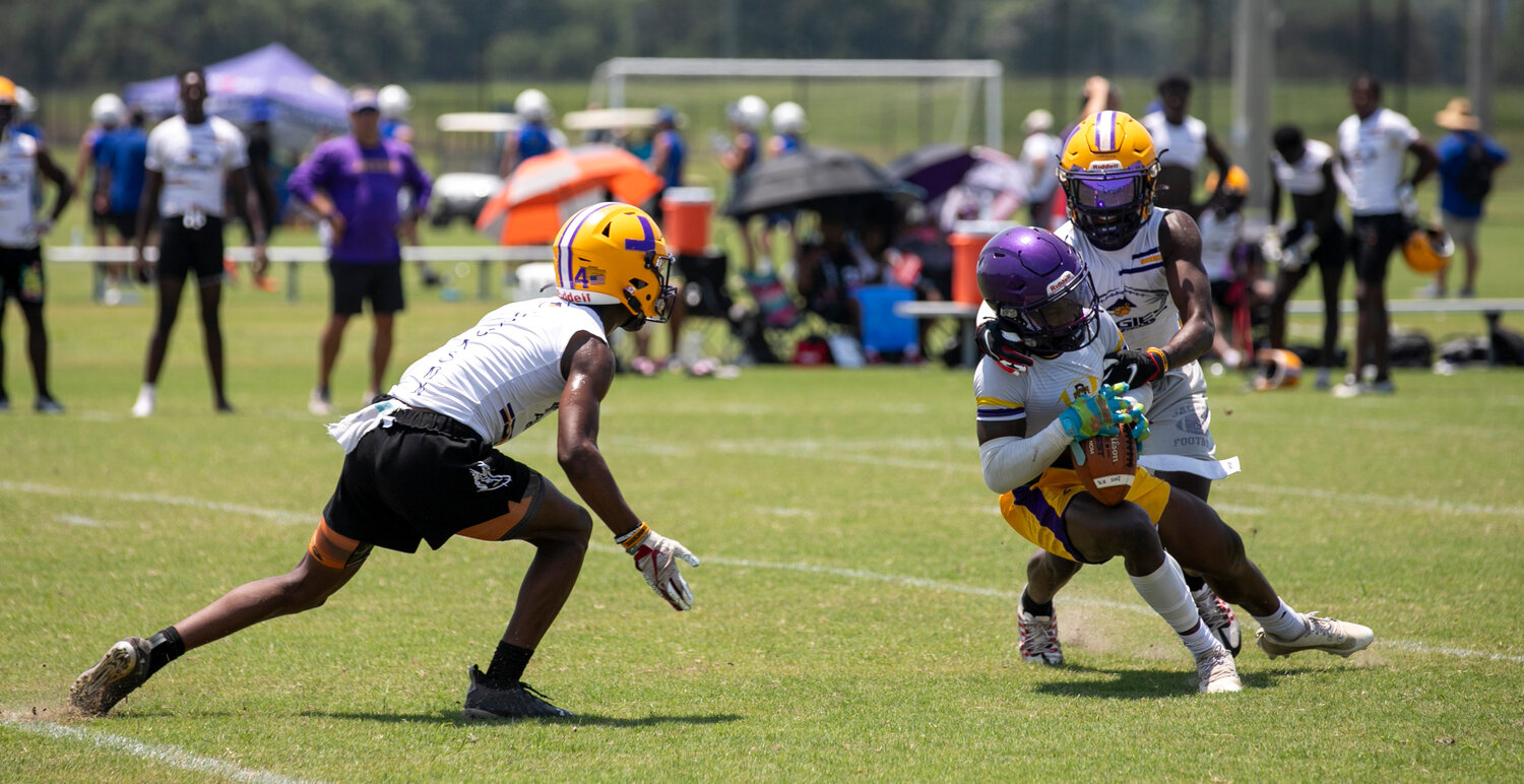 Daphne junior RJ Dailey completes a catch in traffic during the Trojans’ second-round contest in bracket play at the Foley 7-on-7 Showdown hosted by Foley Sports Tourism last Thursday, June 29.