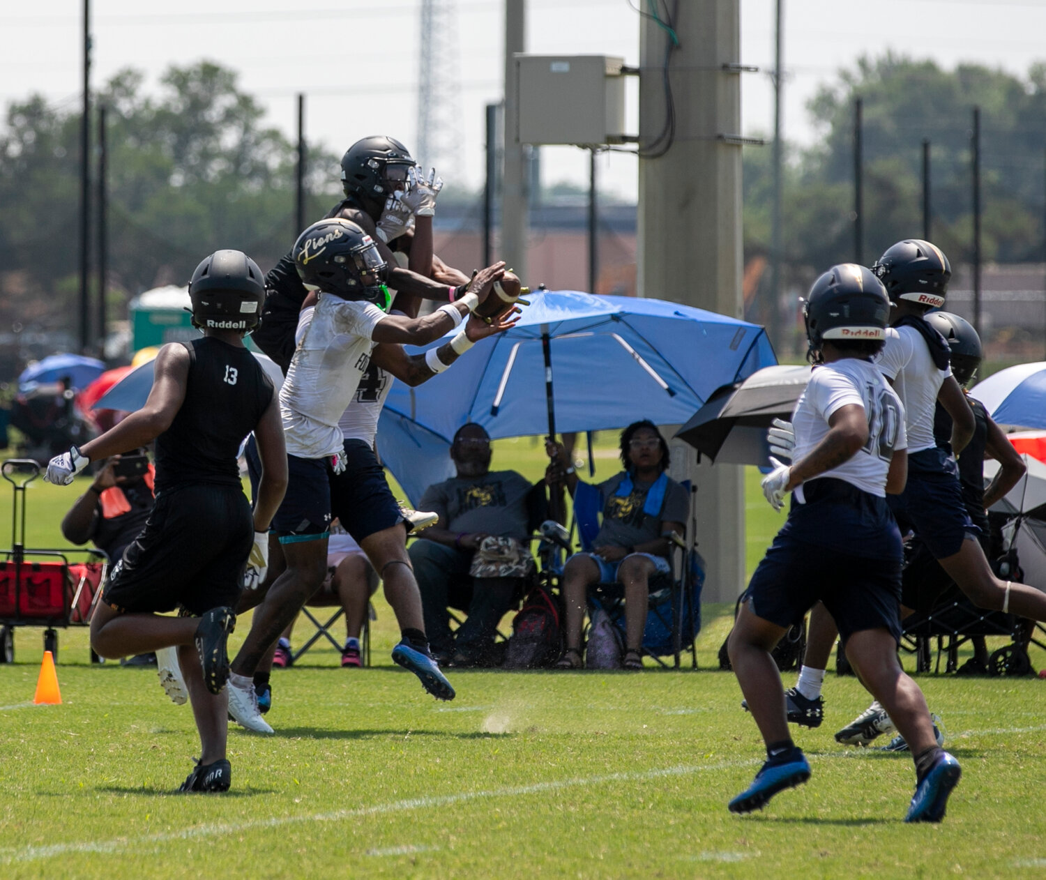 Foley senior Perry Thompson leaps in for a game-sealing interception to advance the Lions past the McAdory Yellow Jackets in the quarterfinals of the championship bracket at Thursday’s Foley 7-on-7 Showdown.